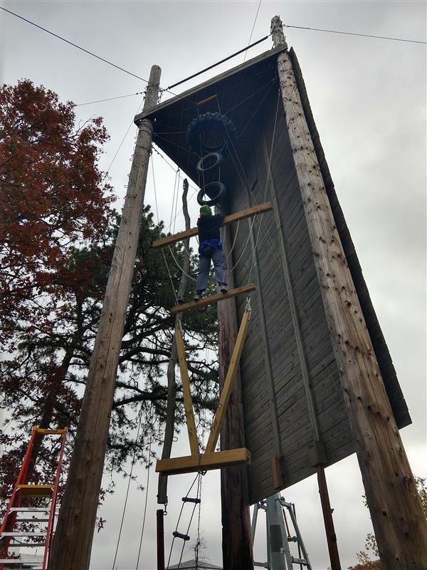 Student climbing on the vertical play pen in adventure education